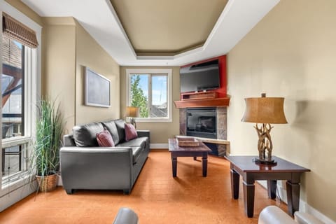 Bright living room with mountain views and a fireplace to unwind.