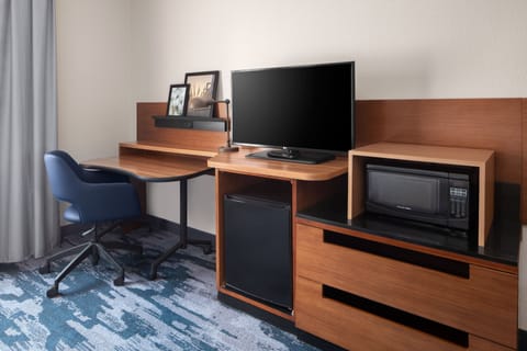 Premium bedding, desk, laptop workspace, blackout drapes