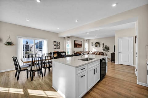 Enjoy meals and moments together at the large dining table for eight, with extra seating at the counter for casual dining or morning coffee. A welcoming space designed for connection and comfort.