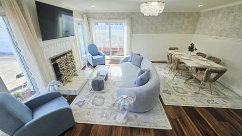 Living Room with curved couch, electric fireplace and big screen Roku TV