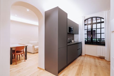 Standard Apartment | Living area | 32-inch flat-screen TV with satellite channels