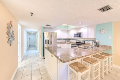Your spacious kitchen features granite countertops, stainless steel appliances, and a breakfast bar perfect for morning coffee or casual meals.