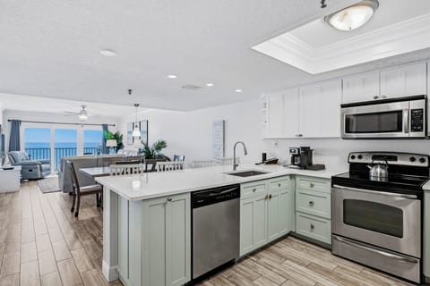 Cook your favorite meals in this bright, modern kitchen while soaking in stunning ocean views through the expansive windows.