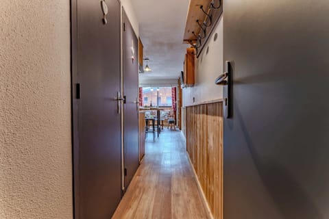 🧥 Welcome to your alpine retreat! This warm wooden hallway leads straight into a cozy, light-filled living area – ideal for ski gear and unwinding after a day on the slopes.