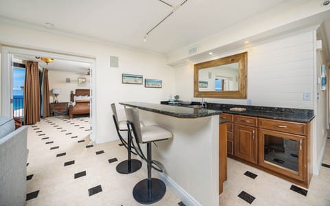 Gather at this elegant wet bar and have a cocktail or glass of wine, featuring a stereo and wine cooler