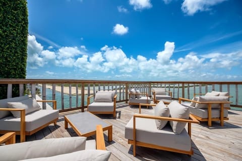 Toast the view from a breezy terrace lounge above water.