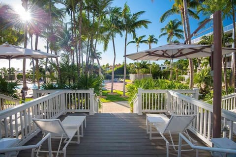 Step onto a breezy deck framed by palms, where sunny skies and swaying shade set the pace for pure relaxation.