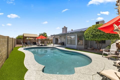 Beautiful, heated pool with loungers, seating and resort style backyard.