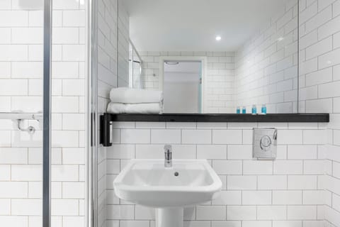 Shower, designer toiletries, hair dryer, towels