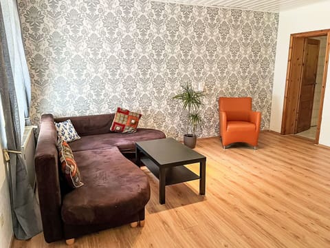 Furniture, Interior Design, Flooring, Floor, Wood Flooring, Wall, Wood, Laminate Flooring, Couch, Living Room