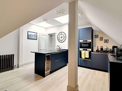 Interior Design, Flooring, Wood, Ceiling, Furniture, Floor, Kitchen, Countertop, Light Fixture, Cabinetry