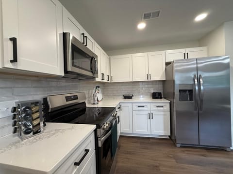 Fully equipped kitchen with oven & fridge can cook and store meals 