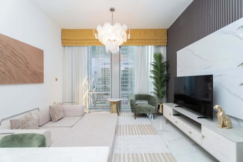 Elegant living room with floor-to-ceiling windows offering serene waterfront views. Stylish décor, plush seating, and natural light create a relaxing, upscale ambiance perfect for unwinding or entertaining.