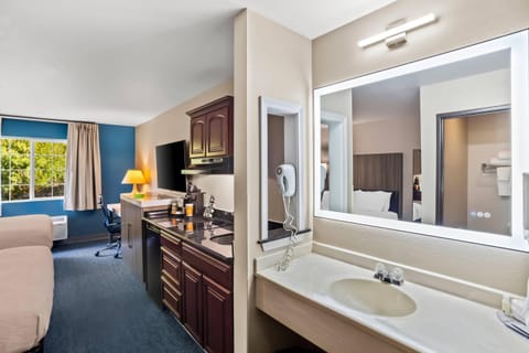 Premium bedding, desk, laptop workspace, blackout drapes