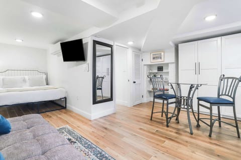 Studio apartment with queen sized bed, sleeper sofa for one, cafe table and additional storage. 