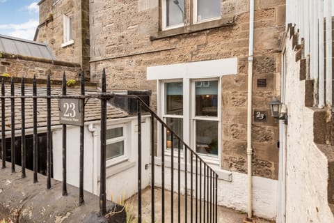 Lower ground floor flat exterior with white-framed windows