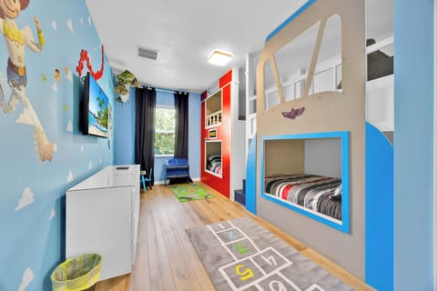 To infinity and beyond! ✨ This vibrant Toy Story-themed bedroom features four full-size bunk beds—perfect for your little space rangers to dream big and play hard!