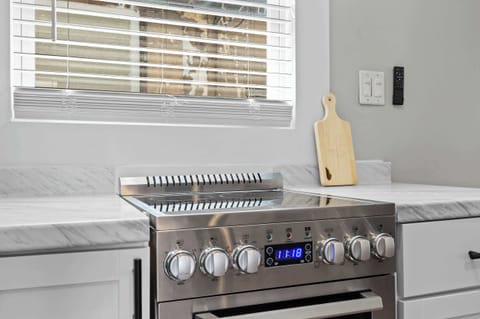 Kitchen: Whip up your favorite meals in this fully equipped kitchen — where modern amenities meet homey charm for a seamless cooking experience.