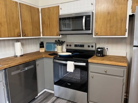 Stainless steel appliances, ample cabinets, and prep space