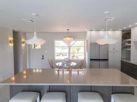 Kitchen - Bar into dining area with sunny kitchen window view