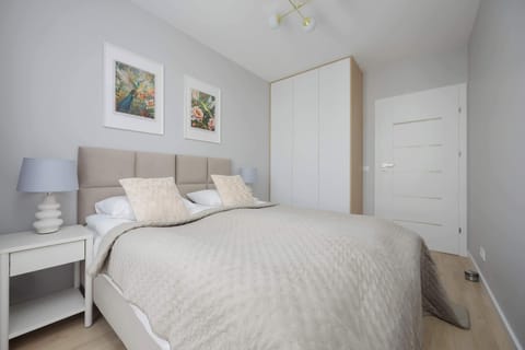 A bright bedroom with a soft bedspread and muted colors invites full relaxation after a busy day.