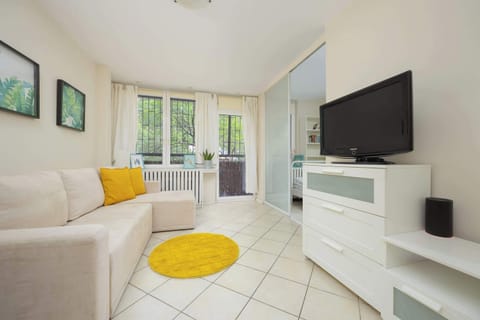 A bright living room with a comfortable corner sofa and TV creates the perfect spot to unwind after a long day.