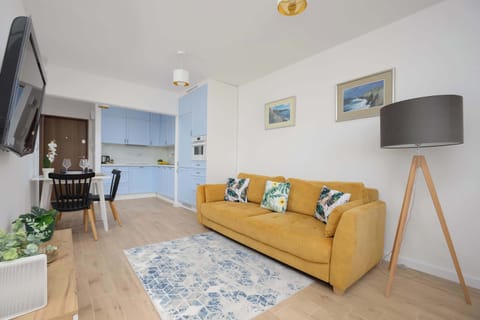 A sunny living room with a designer lamp and large rug brings a warm character to the space.