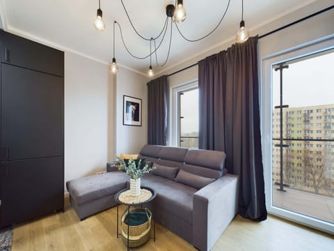 Cozy seating area with a small round table, a sofa, and elegant decor.