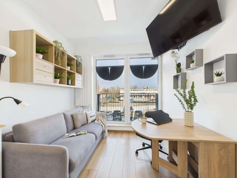 Another shot of the living area from a slightly different perspective, showing the full layout. The combination of white, gray, and wooden elements makes the space elegant.