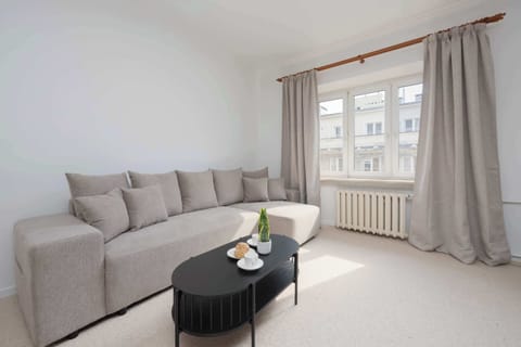 Cozy living room with a corner sofa and designer coffee table creates a warm, homely atmosphere.