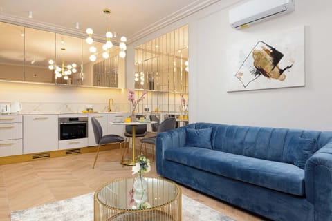 Elegant living room with a comfortable sofa bed, Smart TV and kitchenette with dining area.