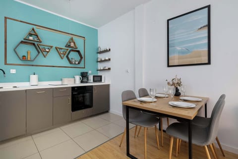 Kitchen area with turquoise accents and modern appliances.