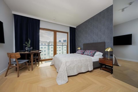 The large window fills the room with natural light, creating a pleasant space for both relaxation and work.