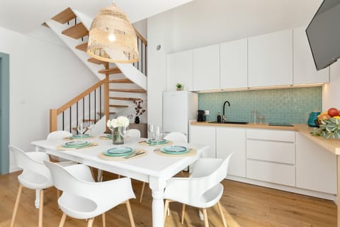 The combination of a classic wooden table and modern chairs adds extra charm to the place.