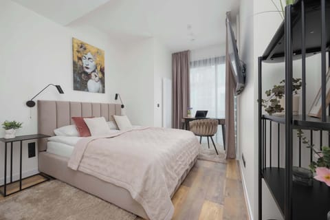 The bedroom with a soft bed and black accents offers elegance and comfort.