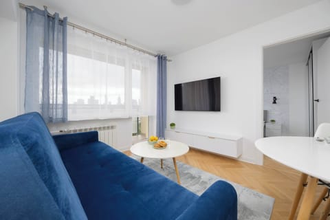 The living room with a large TV and comfy sofa invites you to relax in the evening with your favorite movie.