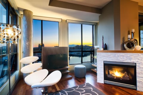 Living room with panoramic sunset views and fireplace warmth