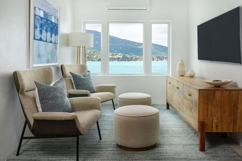 This guest suite strikes a soothing chord of relaxation with a king bed, private sitting area, and smart TV.