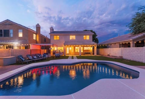 Outdoor canopy with lounge area, heated optional sparkling pool, fire pit, and additional lounging areas.