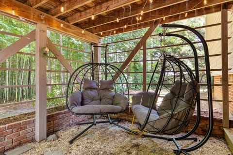 The string lights create the perfect ambience when swinging in the egg chairs.