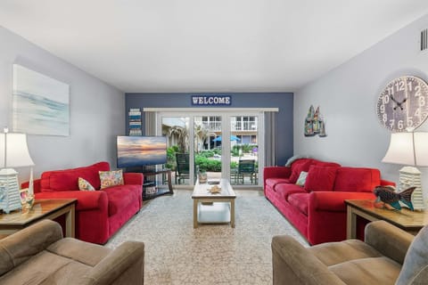 Unwind in this bright beach condo featuring comfortable seating, coastal décor, and a private patio overlooking the resort pool. Ideal for a relaxing beach vacation stay near the shore and resort amenities.