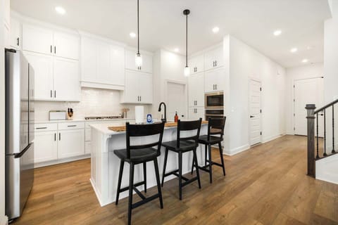 The kitchen is fully stocked and features new appliances and a large kitchen island.