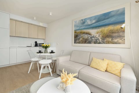 A relaxing living room with a large sectional sofa and decorative cushions. The perfect space to enjoy a movie night.