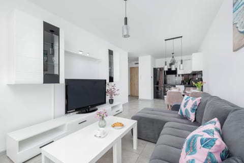 The living room's modern and stylish decor creates a welcoming atmosphere. 