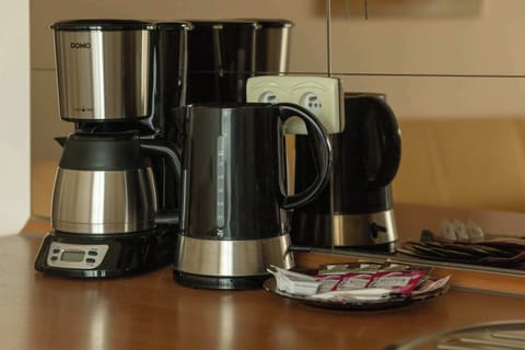 A close-up of the coffee maker and electric kettle, which will make guests' stay more pleasant.