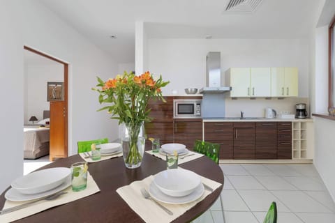 Dining table set for four, next to kitchen.


