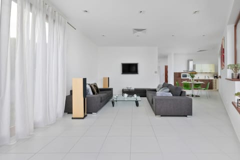 Elegant living room with large windows and cozy sofa..

