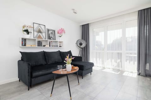 Relax in the stylish living room with a comfortable sofa and modern decor.