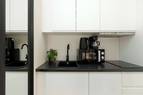 A modern kitchen with a coffee machine and induction hob makes meal prep quick and convenient.
