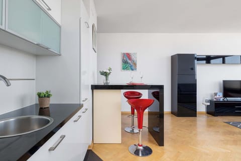 The sleek design of the kitchenette blending seamlessly with the living area.